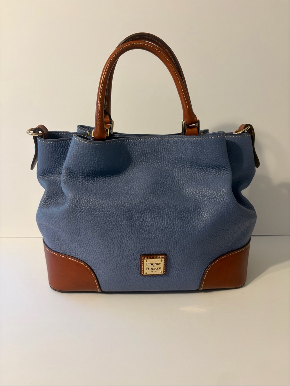 Dooney & Bourke Blue Pebble grain Brenna satchel with brown leather strap